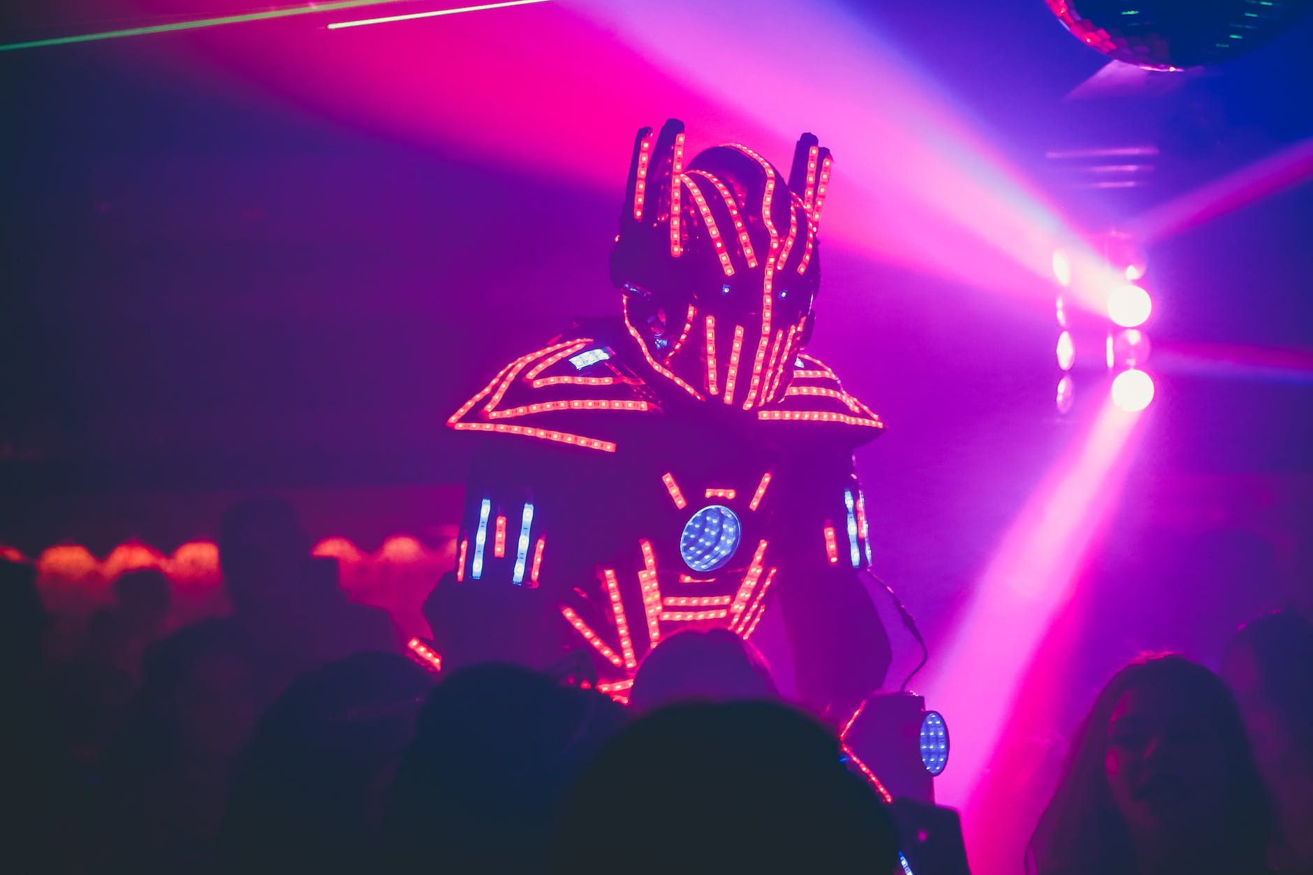 unrecognizable dj in creative costume performing show in nightclub